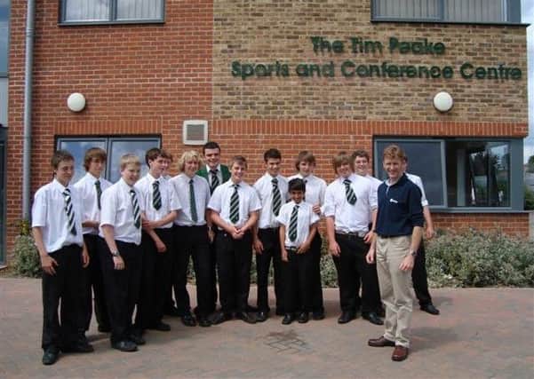 Astronaut Tim Peake, a former pupil, pictured outside the sports centre carrying his name with pupils on a visit