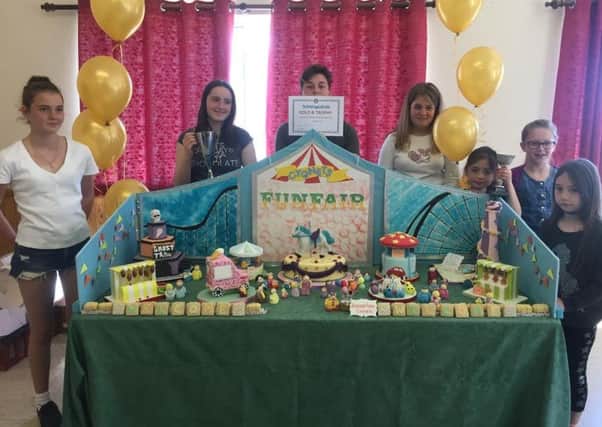 Bognor Regis Cygnets pictured with their Gold standard award winning table, 'All the Fun of the Fair'