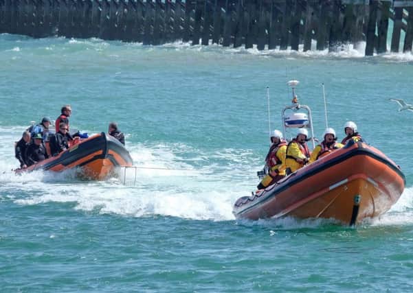 Divers being towed in by the Atlantic 85 lifeboat. Picture: Richard Ball