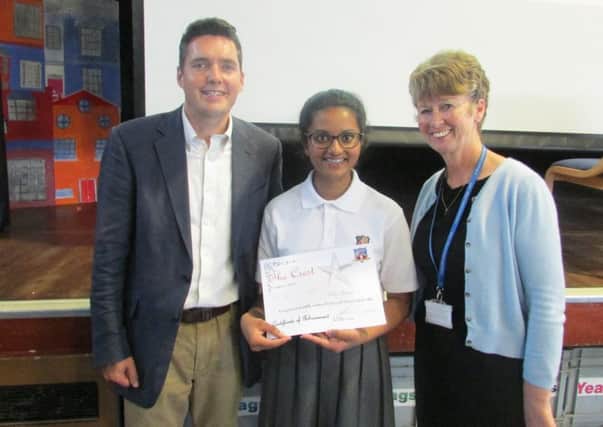 Bexhill and Battle MP Huw Merriman and  Principle Miss Cronin present a certificate to a St Richard's student