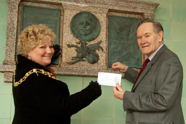 Mayor Carolyn Heaps is pictured siome years ago handing a cheque to Peter Goldsmith for the memorial plaque at the Bandstand to be renovated