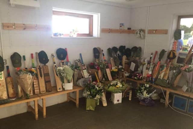 Bats, flowers and caps in the West Chiltingtington changing room after the death of Tim Monday