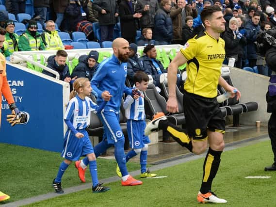Albion captain Bruno leads out two mascots at home to Burton last season. Picture by Phil Westlake (PW Sporting Photography)