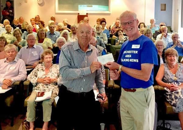 Dereck Double, president of Chichester Rotary Club, presents a cheque to Dave McVittie, chairman of Chichester Area Talking News