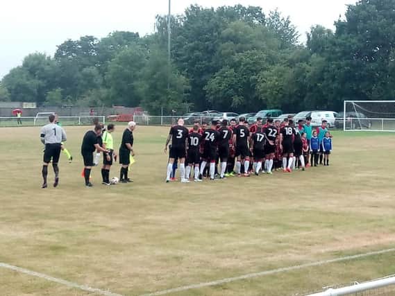 Crawley Town, in black, and Oakwood players shake hands with each other before the start of the first game.
Picture by Graham Carter