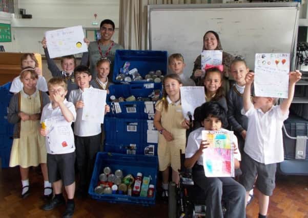 Orca Class pupils Jenna Sutton, Ava Peddar, Alex Knight and Ryan Horrod, Octopus Class pupils Mina Usher, Krishna Nirmala Ranjith, Louis Banks, Jack Beverton, and Jellyfish Class pupils Nia Bashford, Ryan Townsend, Charlie Hollick and Viona Gashi present the food collection to Sussex Aid for Refugees