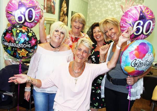 Jean Hallford, centre, celebrates 60 years at Salon 128 with colleagues, from left, Ally Costello, Morag Wale, Rose Wade and Sue Cassey. Photo by Derek Martin DM17734694a