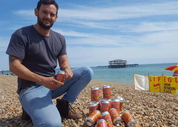 Brewer Dan Gale with Lost Pier beers with the remains of the West Pier in the background