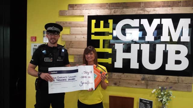 PC Rob Luff presented the cheque to Gym Hub manager Ruth Stevens