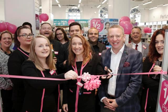 Cutting the ribbon on Friday as the new store opened