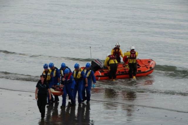 Man rescued from Selsey beach. Pictures by Selsey RNLI