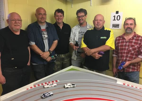 East Worthing Scalextric Club meets on the second and fourth Wednesday of the month at East Worthing Community Centre in Pages Lane. Far left is John Watts, 70, second from left is Darren McHarg, 41, and second from right is Terry Smith, 61