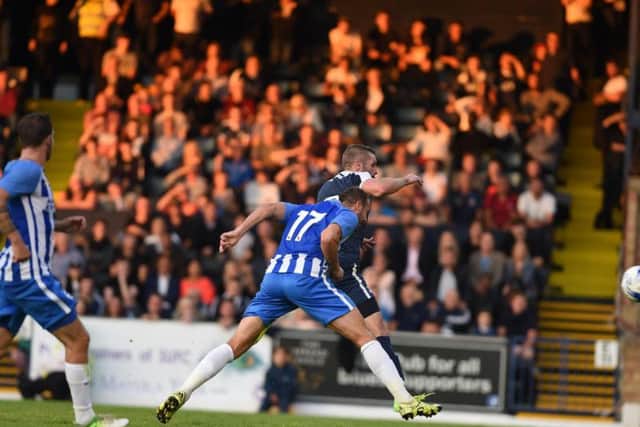 Glenn Murray heads home the third. Picture by Phil Westlake (PW Sporting Photography)