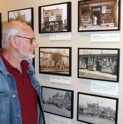 Volunteer David Beal with pictures of shops DM17737435a