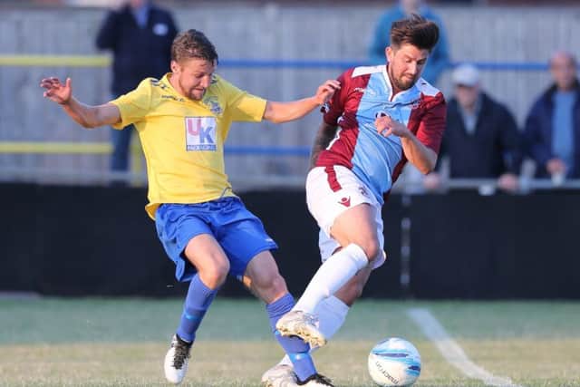 Lee Carey tries to turn away from an Eastbourne Town opponent. Picture courtesy Scott White