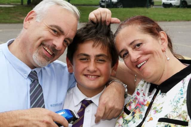 DM17737060a.jpg Oscar Thompson,10, has his head shaved in aid of St. Barnabas Hospice. Pictured with mum and dad Andrew and Irena. Photo by Derek Martin. SUS-170725-180247008