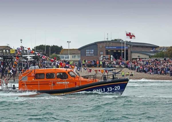 Crowds watch the first launch of the new lifeboat recently
