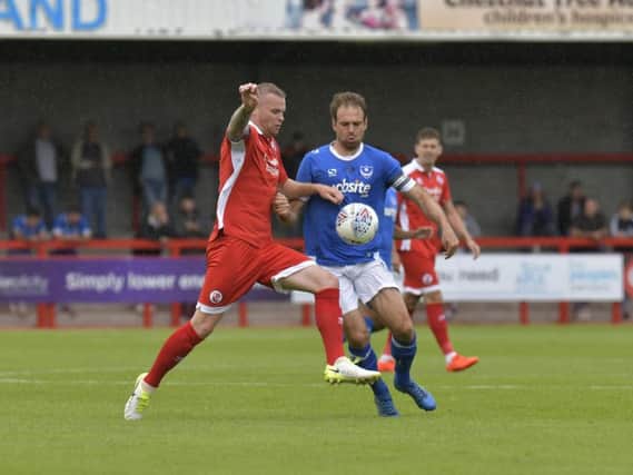 Mark Connolly tussles for the ball during this afternoon's friendly with Portsmouth. Picture by Neil Marshall.