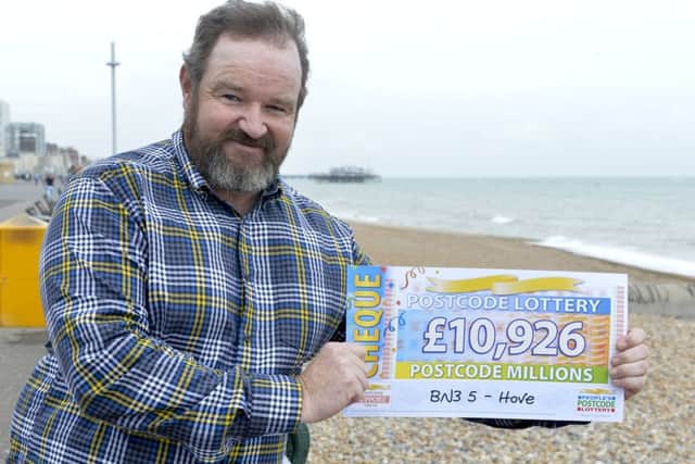Pictured at the seafront in Hove are the Peoples Postcode Lottery winners from postcode BN3 5 receiving their winner's cheques. Shown with his winning cheque is Adrian Bradley. All pictures cleared for release.  Pictures Copyright Darren Casey / DCimaging 07989 984643 Peoples Postcode Lottery