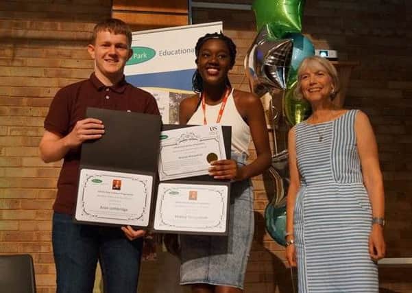 Aron Lethbridge and Khalayi Wangamati (Mike Baker Scholars of the Year) receive their awards from Chrissy Baker