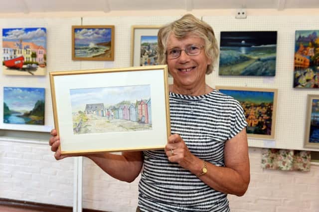 Patricia Hall with her painting Beach huts in Ferring. Picture: Liz Pearce LP170570