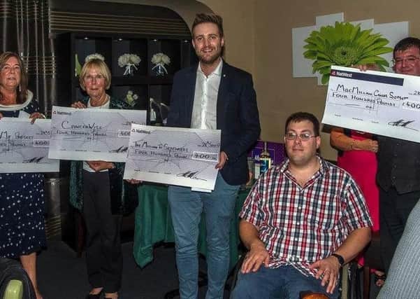 James Rushman presented cheques for Â£400 to representatives from the chosen charities
