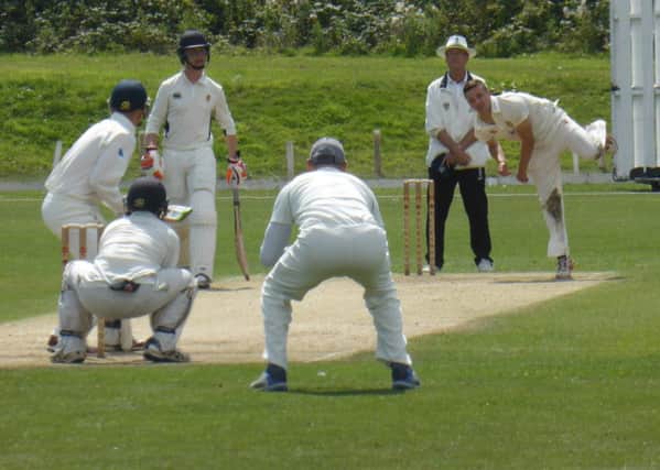 Match-winner Elliot Hooper bowling for Hastings Priory against Preston Nomads. Pictures by Simon Newstead