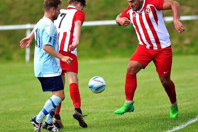 Charlie Romain battles for the ball at Worthing United on Saturday. Picture by Stephen Goodger