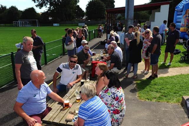 Some of the crowd relax with drinks. Picture: Stephen Goodger
