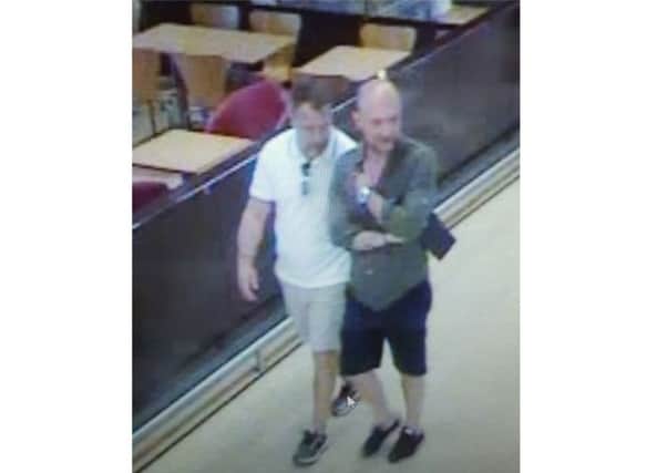 Police believe the two men pictured, working with others, have pocketed Â£20,000 by targeting supermarket shoppers. Picture: Sussex Police