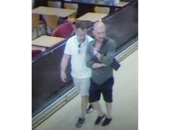 Police believe the two men pictured, working with others, have pocketed 20,000 by targeting supermarket shoppers. Picture: Sussex Police