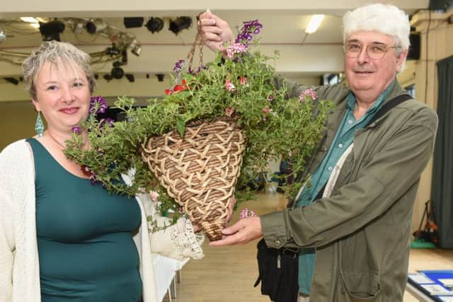 Flora Challenge Cup winner Lorraine Saunders holds her hanging basket with the help of her dad. Picture: Liz Pearce LP170784