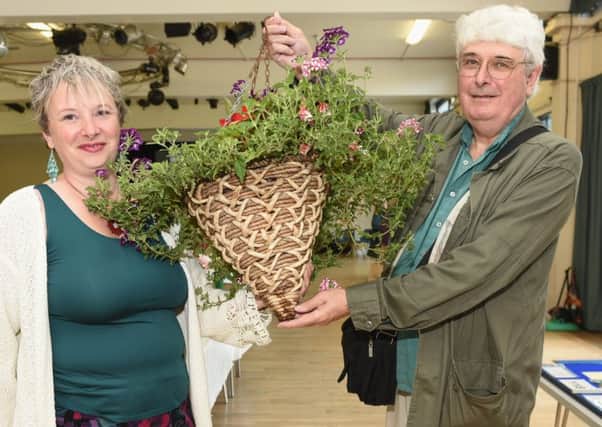 Flora Challenge Cup winner Lorraine Saunders holds her hanging basket with the help of her dad. Picture: Liz Pearce LP170784