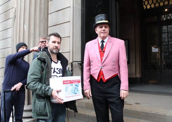 Doug Maw outside the Bank of England building in Threadneedle Street, London, handing over his petition against using animal fat in the new polymer banknotes.