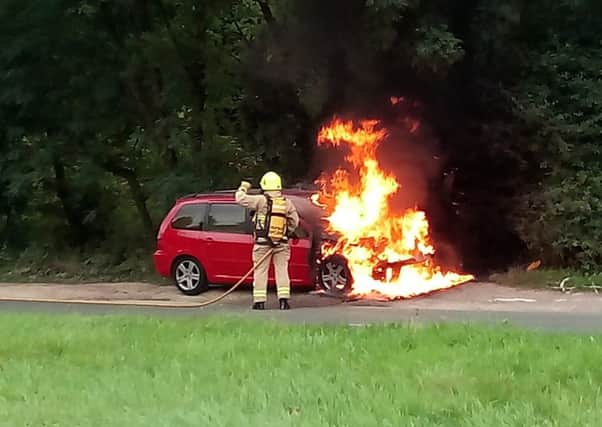 Firefighters battle car fire on A264