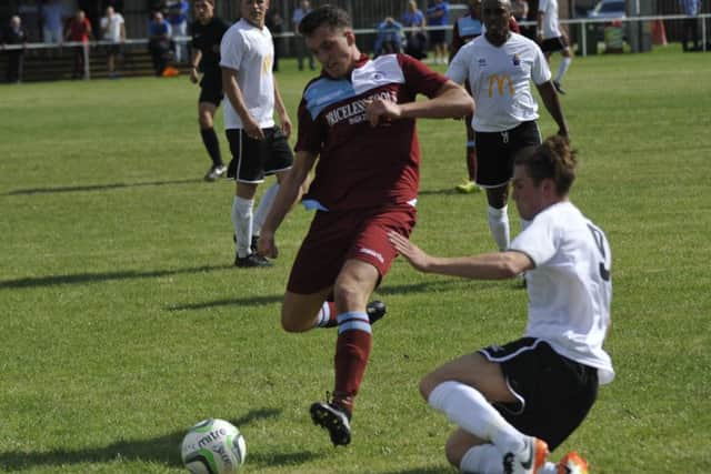 Liam Ward goes in for a tackle against Eastbourne United AFC.