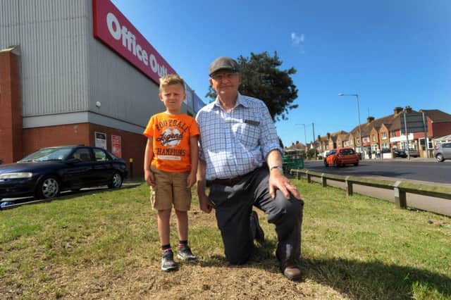 Stephen Kittoe with grandson Dylan Jegorovs-Clarke at the site where the pine trees have been cut down