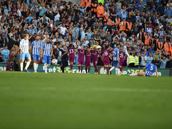 Manchester City celebrate as Brighton & Hove Albion look dejected after the second goal put in by Lewis Dunk. Picture by PW Sporting Pics