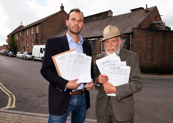 Adrian Burrows (left) and John Munro, founders of Affordable  Housing in Arundel (AHA), have set up a petition against a retirment development, which they are campainging  to be replaced by affordable housing.   Pictured are L-R: Adrian Burrows and John Munro by the site of the proposed development. Picture: Liz Pearce