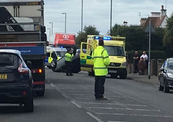 Police and the ambulance service were called to the overturned car in Grinsted Lane in Lancing. Picture: James Butler