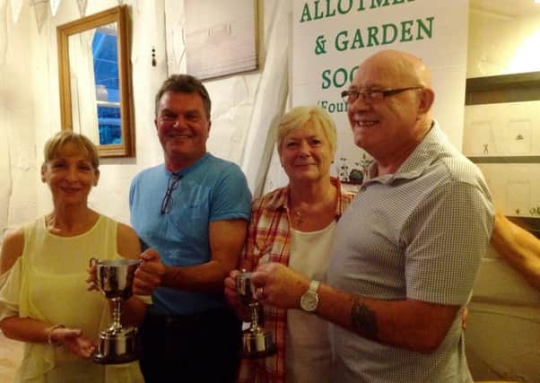 Marilyn Wyers and Brian Rodgers, left, won the prize for best whole plot, measuring ten rods, while Sue and Dave Nagle won best half plot, measuring five rods