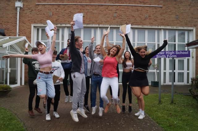 A delighted Vickie Smith (Head of Sixth Form) jumps for joy with her students