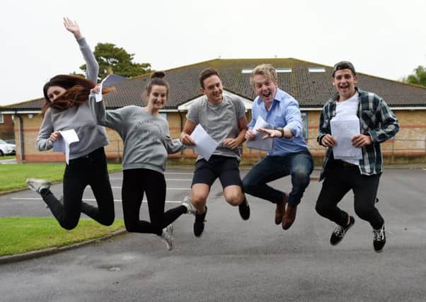 Students at The Littlehampton Academy jumping for joy after getting their results. Pictures: Liz Pearce