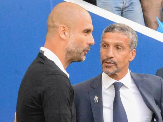Albion boss Chris Hughton pictured with Manchester City manager Pep Guardiola. Picture by Phil Westlake (PW Sporting Photography)