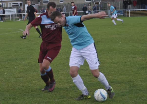 Little Common forward Lewis Hole closes down an AFC Varndeanians opponent. Pictures by Simon Newstead