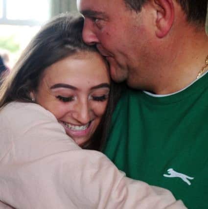 Taylor Barker, 16 gets a hug from dad Nathan Barker. ks171007-11
