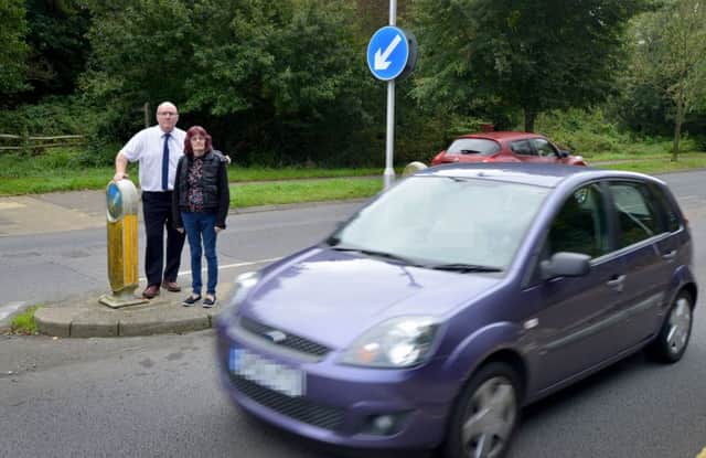 Cllr Phil Scott and Gillian Baker pictured on the Churchwood Drive traffic island
