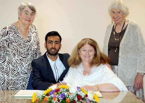Felpham couple Noor-A Alam and Cherry Tyrrell signing the register