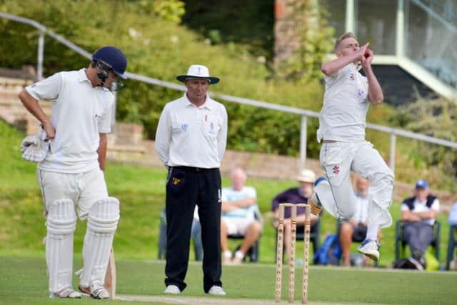 Hastings Priory pace bowler Adam Barton charges in.