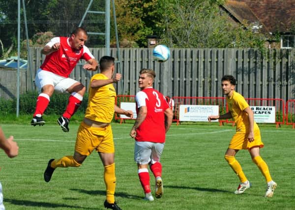 Andy Reynolds leaps for the ball in Bosham's clash with Upper Beeding / Picture by Kate Shemilt